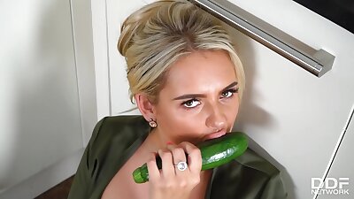 Busty blonde housewife, Katie T is masturbating with a cucumber and enjoying every second of it