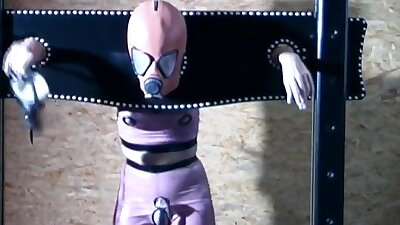 Gimp girl locked in box and pillory